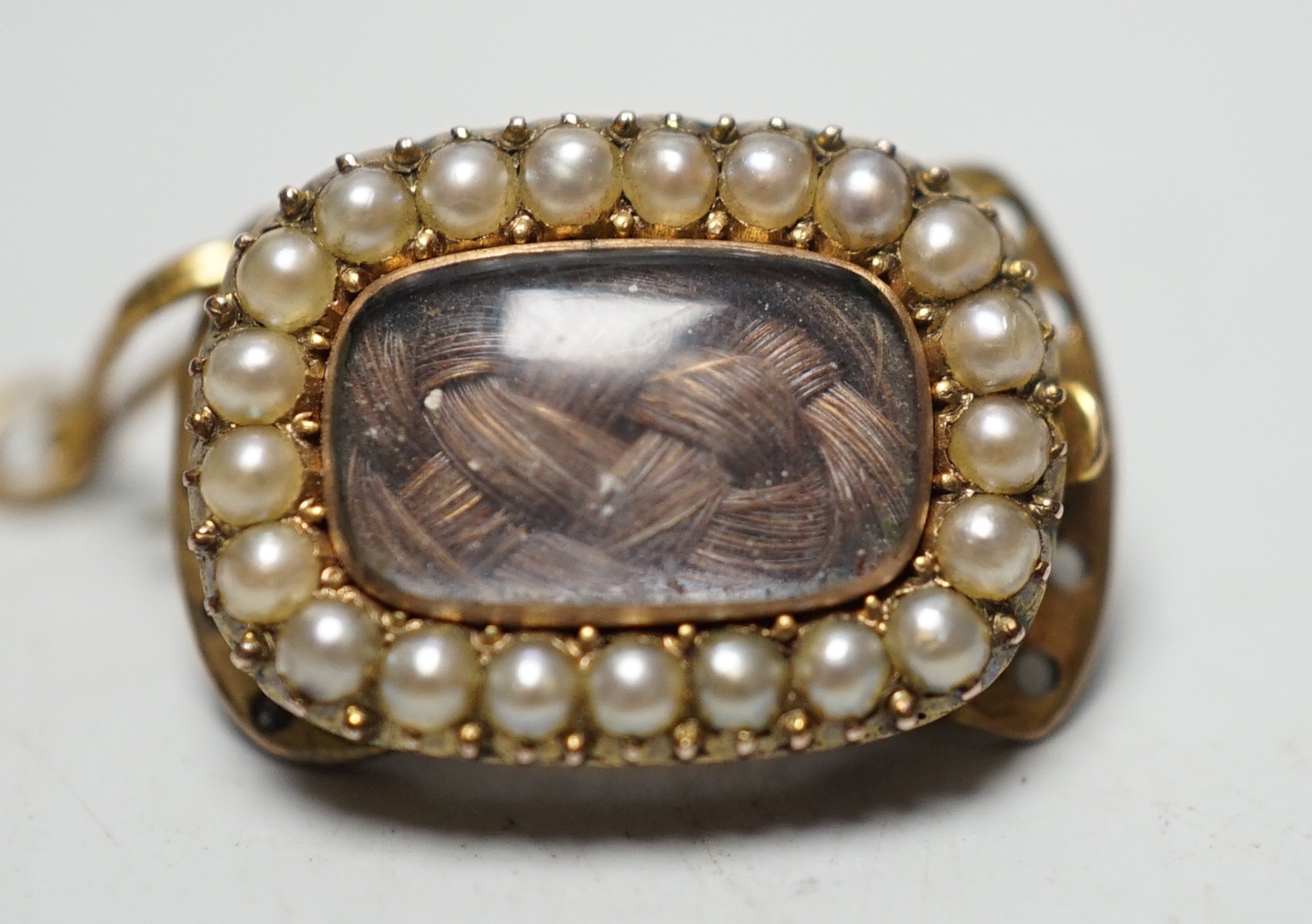 A George III yellow metal and plated hair mourning brooch, engraved 'BH, July 11th, 1815', 16mm, (ex clasp, now mounted as a brooch).